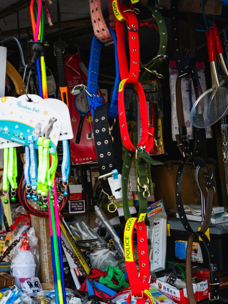 pexels-photo-37051950-37051950 Vibrant pet accessories displayed in a bustling Colombo street market, showcasing dog collars and leashes.